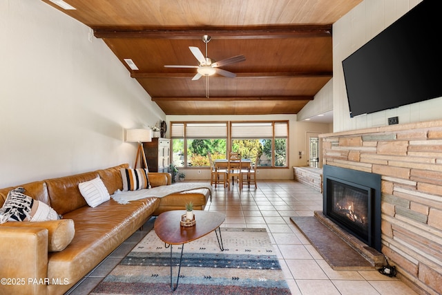 living area with wood ceiling, light tile patterned floors, ceiling fan, beam ceiling, and a fireplace