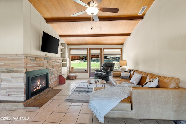 living room featuring lofted ceiling with beams, wooden ceiling, light tile patterned flooring, a ceiling fan, and built in shelves