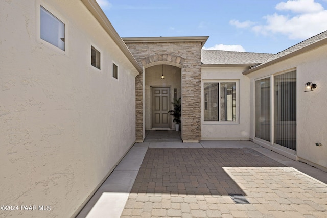 property entrance featuring a patio area