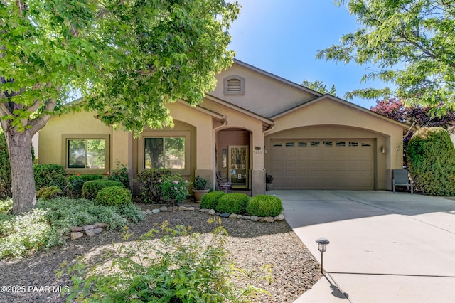 5461 N Bremont Way, Prescott Valley, AZ 86314 - view of front facade with stucco siding, a garage, and concrete driveway