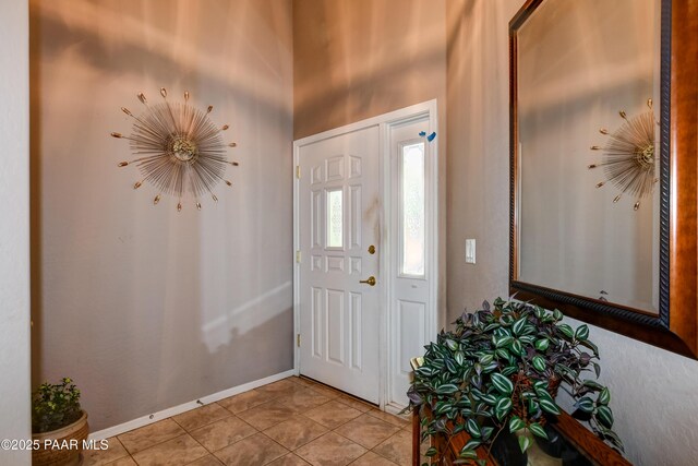 5461 N Bremont Way, Prescott Valley, AZ 86314 - entryway featuring light tile patterned floors, a high ceiling, and baseboards