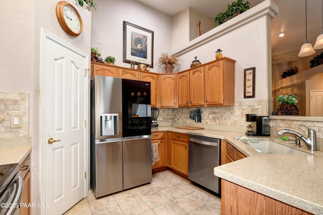 5461 N Bremont Way, Prescott Valley, AZ 86314 - kitchen with appliances with stainless steel finishes, a sink, tasteful backsplash, light tile patterned floors, and light countertops