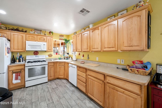 kitchen featuring light countertops, white appliances, visible vents, and wood tiled floor