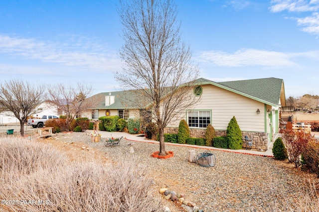 ranch-style home with stone siding