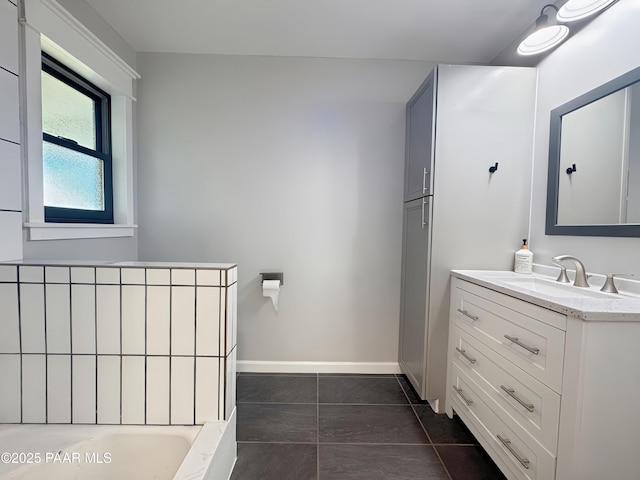 bathroom featuring vanity, tile patterned floors, and a tub to relax in