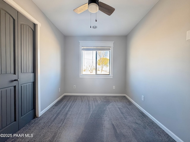 empty room featuring carpet floors and ceiling fan