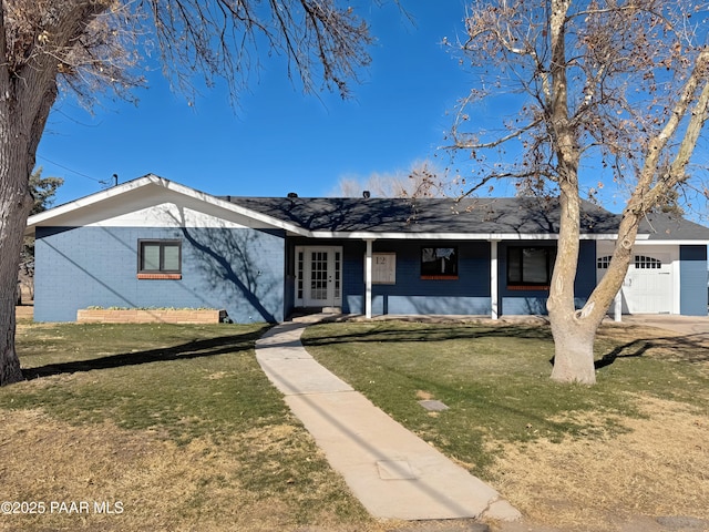 ranch-style home featuring a garage and a front lawn