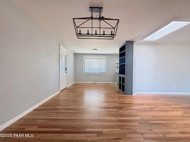 interior space with wood-type flooring and a skylight