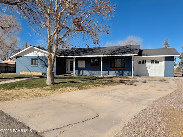 ranch-style home with a garage and a front lawn