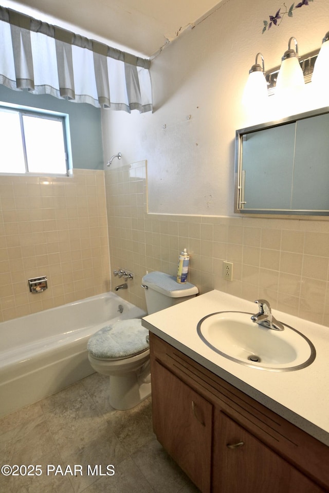 856 E Damion Loop, Chino Valley, AZ 86323 - bathroom featuring vanity, tile patterned flooring, toilet, shower / tub combination, and tile walls