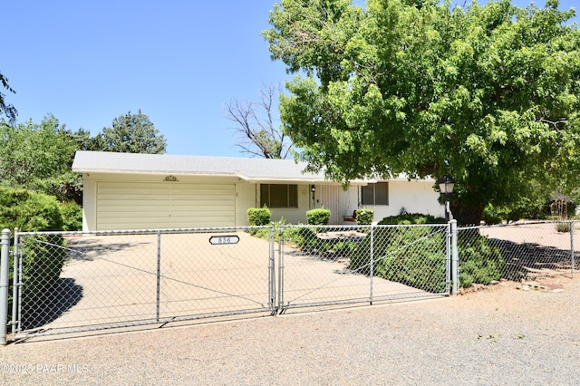 856 E Damion Loop, Chino Valley, AZ 86323 - view of front of property with concrete driveway, an attached garage, a fenced front yard, and a gate