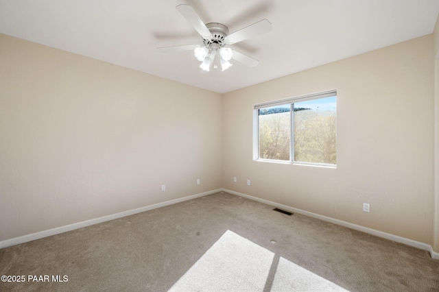 carpeted empty room featuring ceiling fan
