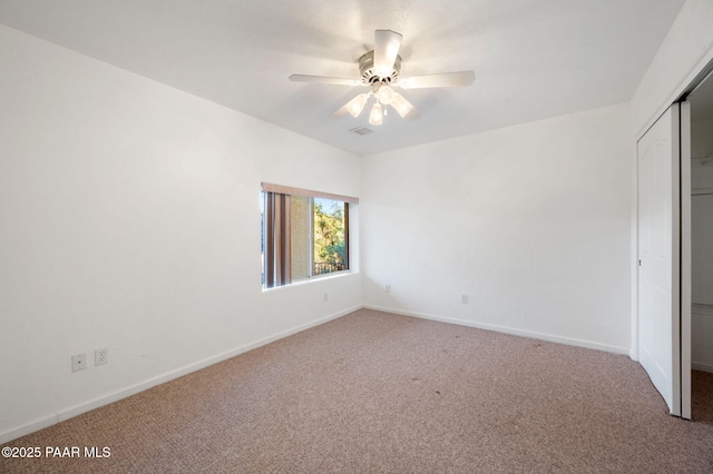 unfurnished bedroom featuring carpet floors, a closet, and ceiling fan