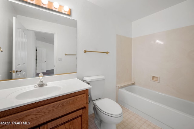 bathroom featuring vanity, toilet, and a tub