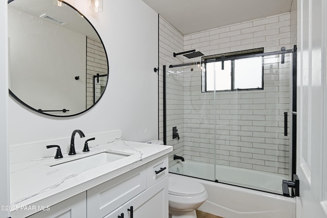 bathroom featuring shower / bath combination with glass door, visible vents, toilet, and vanity