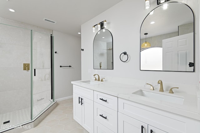 full bathroom with a sink, visible vents, a shower stall, and tile patterned floors