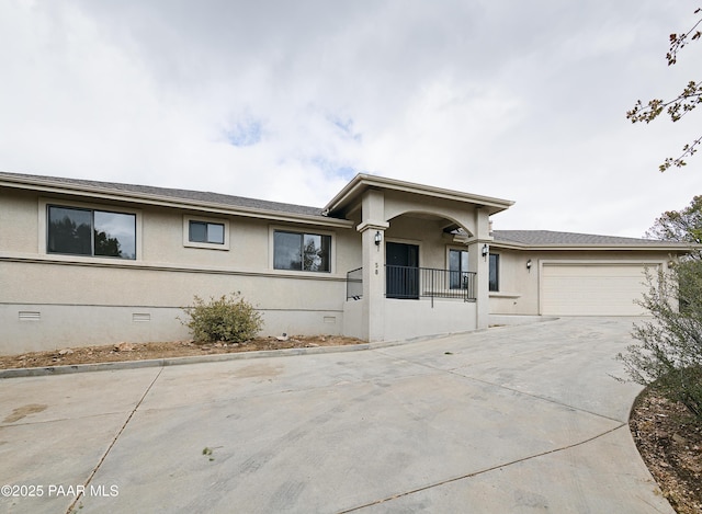 single story home with crawl space, stucco siding, an attached garage, and driveway