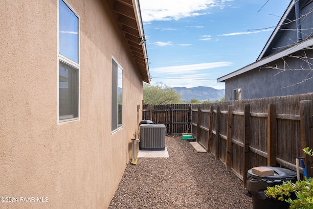 view of yard with a mountain view and central AC unit