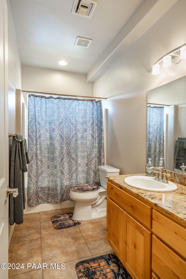 bathroom with tile patterned flooring, vanity, and toilet