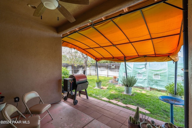 view of patio with area for grilling and ceiling fan