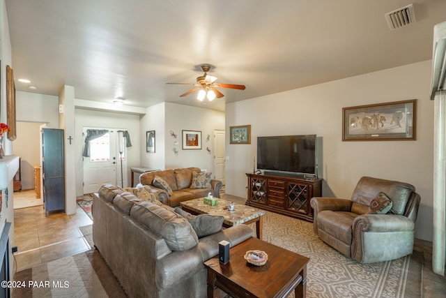 living room with ceiling fan and light tile patterned floors