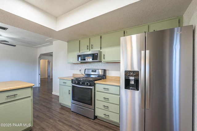 kitchen with appliances with stainless steel finishes, light countertops, and green cabinets