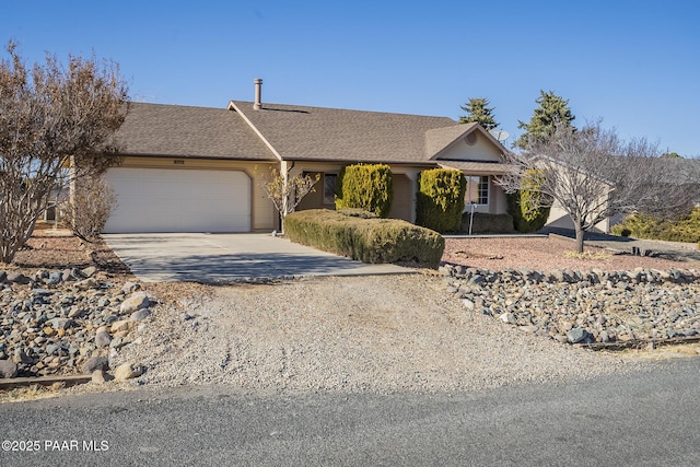 view of front of home with concrete driveway, a shingled roof, and an attached garage