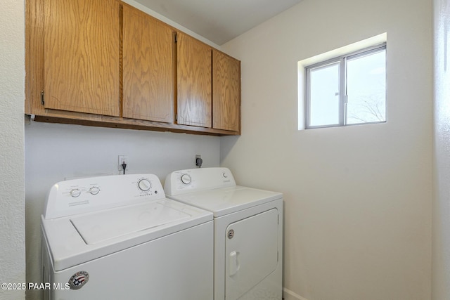 clothes washing area with cabinet space and washing machine and clothes dryer