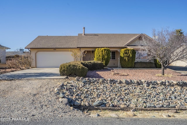 ranch-style house with concrete driveway and an attached garage