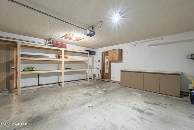 garage with a sink and a garage door opener