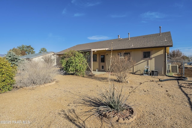 rear view of property featuring a gate