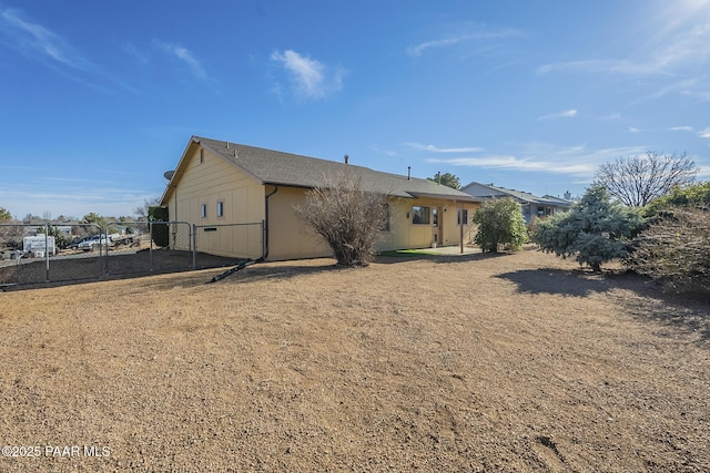 back of property with fence and a yard