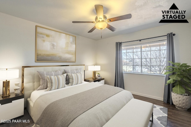 bedroom featuring baseboards, dark wood finished floors, and a ceiling fan