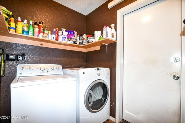 laundry area featuring independent washer and dryer and a textured ceiling