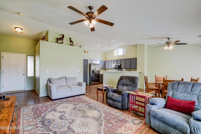 living room with hardwood / wood-style flooring, plenty of natural light, ceiling fan, and lofted ceiling