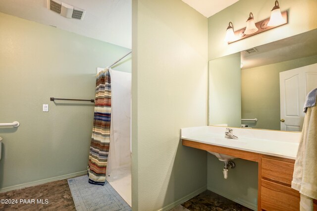 bathroom with sink and a shower with shower curtain