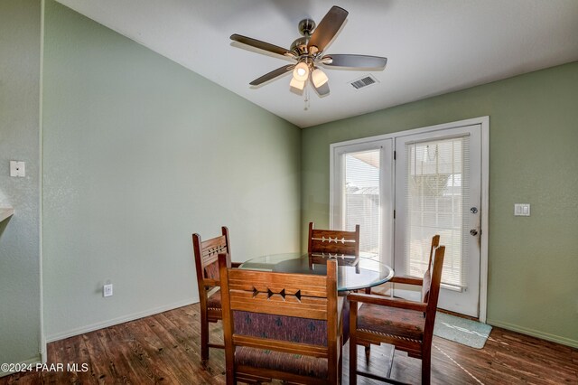 dining room featuring ceiling fan and dark wood-type flooring