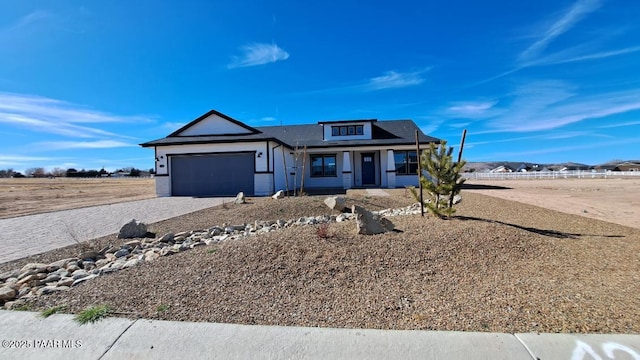 view of front of property with a garage and decorative driveway