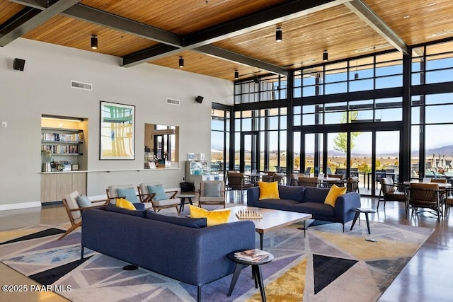 common area with a high ceiling, beamed ceiling, and wooden ceiling