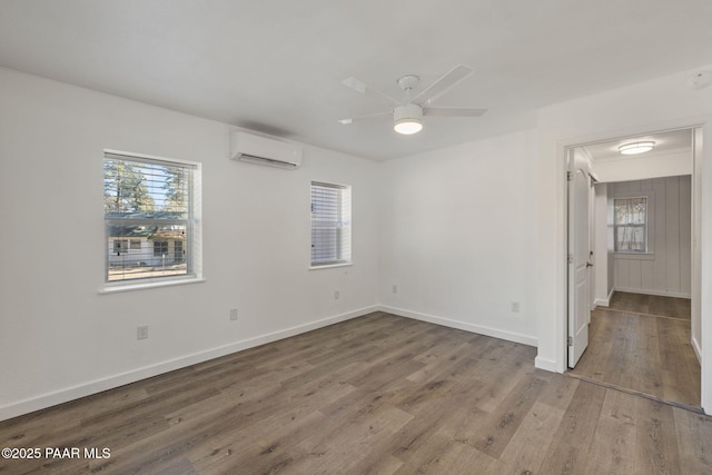 1467 N Vyne St, Prescott, AZ 86305 - unfurnished bedroom with multiple windows, a wall mounted AC, wood finished floors, and baseboards