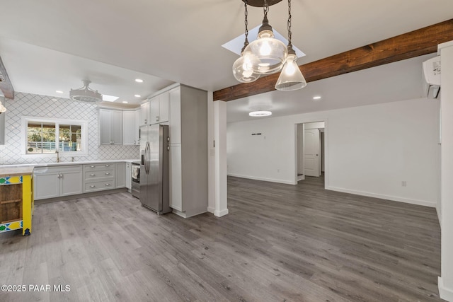 1467 N Vyne St, Prescott, AZ 86305 - kitchen with wood finished floors, stainless steel appliances, beam ceiling, open floor plan, and backsplash