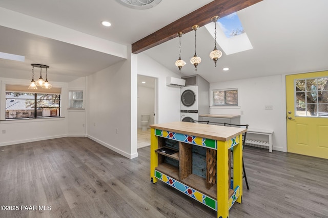 1467 N Vyne St, Prescott, AZ 86305 - rec room featuring a wall mounted AC, stacked washer / drying machine, wood finished floors, baseboards, and lofted ceiling with skylight
