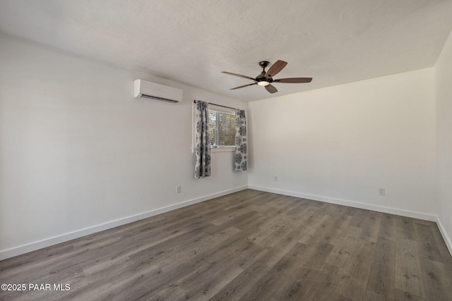 1467 N Vyne St, Prescott, AZ 86305 - spare room featuring a ceiling fan, an AC wall unit, baseboards, and wood finished floors