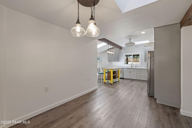 1467 N Vyne St, Prescott, AZ 86305 - kitchen with decorative backsplash, light countertops, baseboards, wood finished floors, and freestanding refrigerator