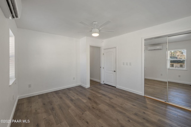 1467 N Vyne St, Prescott, AZ 86305 - unfurnished bedroom featuring a wall unit AC, baseboards, a closet, and wood finished floors