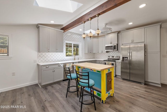 1467 N Vyne St, Prescott, AZ 86305 - kitchen with a skylight, appliances with stainless steel finishes, butcher block counters, baseboards, and beamed ceiling