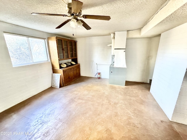 spare room with ceiling fan and a textured ceiling