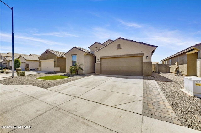 10429 W Crown King Rd, Tolleson, AZ 85353 - mediterranean / spanish-style house with stucco siding, a residential view, concrete driveway, an attached garage, and a tiled roof