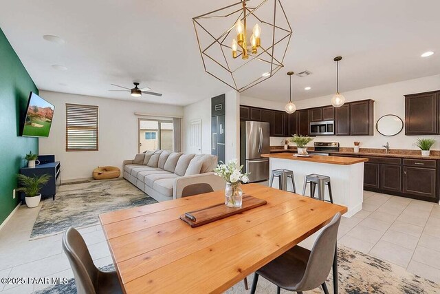 10429 W Crown King Rd, Tolleson, AZ 85353 - dining area with light tile patterned flooring, a ceiling fan, recessed lighting, and a chandelier