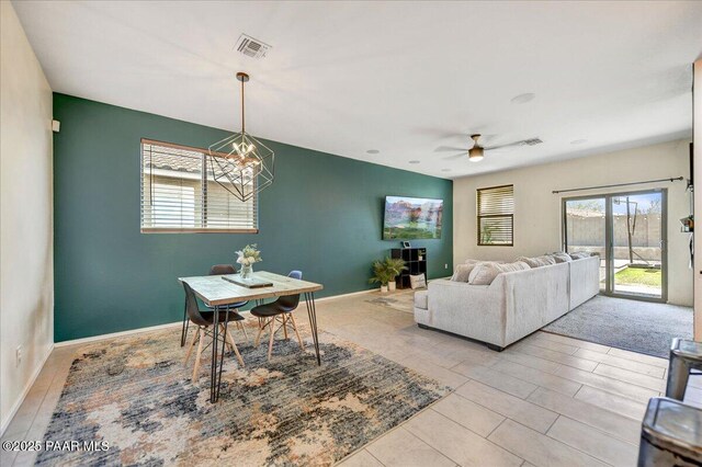10429 W Crown King Rd, Tolleson, AZ 85353 - living room featuring a ceiling fan, a chandelier, and baseboards